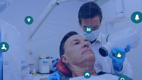 Animation-of-networks-of-connections-with-icons-over-man-in-dentist-chair