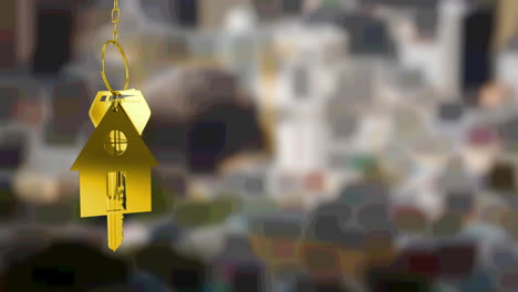 Animation-of-gold-house-key-fob-and-key,-hanging-in-front-of-blurred-city-view