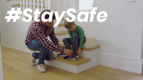 Animation-of-stay-safe-text-over-father-and-son-at-home