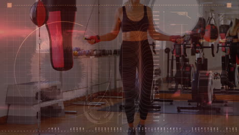 Digital-interface-with-data-processing-against-caucasian-female-boxer-jumping-ropes-at-the-gym