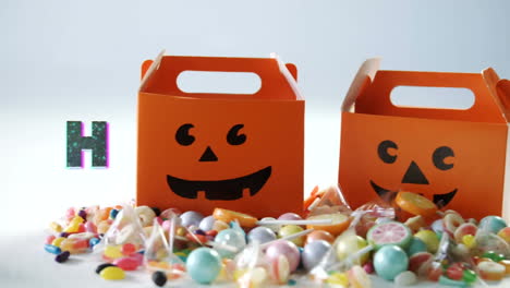 Animation-of-halloween-greetings-over-multiple-candies-and-boxes-in-background