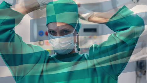 Animation-of-flag-of-greece-waving-over-female-surgeon-in-operating-theatre
