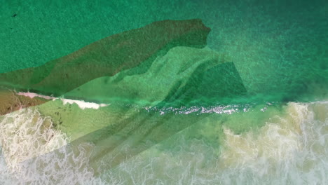 Digital-composition-of-waving-netherlands-flag-against-aerial-view-of-the-beach-and-sea-waves