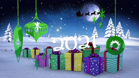 2021-text-and-christmas-decorations-hanging-against-christmas-gifts-on-winter-landscape
