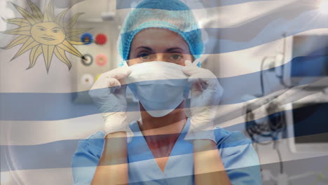 Animation-of-flag-of-uruguay-waving-over-female-surgeon-in-operating-theatre
