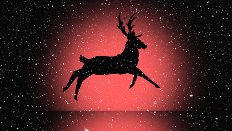 Snow-falling-over-silhouette-of-reindeer-running-against-orange-background