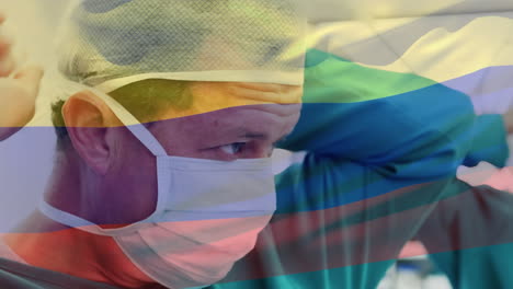 Animation-of-flag-of-colombia-waving-over-surgeons-in-operating-theatre