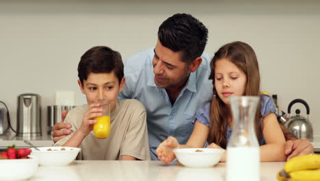 Father-chatting-with-his-children-having-breakfast