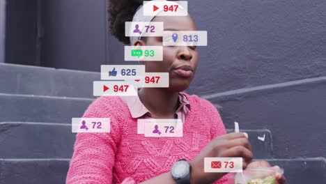 Animation-of-social-media-notifications-over-african-american-woman-eating-takeaway-in-city
