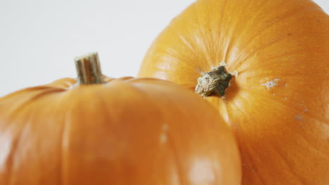 Composition-of-halloween-orange-pumpkins-against-white-background