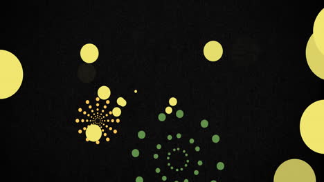 Animation-of-green-and-orange-firework-explosions-and-bokeh-yellow-light-spots-on-black-background