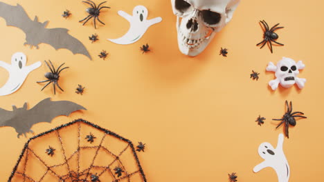 Close-up-of-multiple-halloween-toys-with-copy-space-against-orange-background