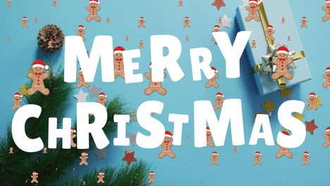 Animation-Des-Textes-„Frohe-Weihnachten“-über-Keksen,-Dekorationen-Auf-Blauem-Hintergrund