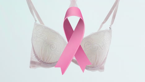 Animation-of-pink-ribbon-over-bra-on-white-background