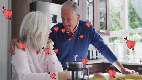 Animation-of-hearts-over-happy-senior-caucasian-couple-drinking-coffee