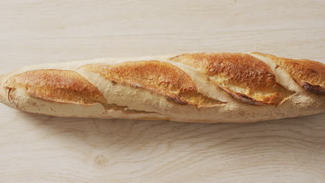 Video-of-close-up-of-baguette-on-a-black-surface