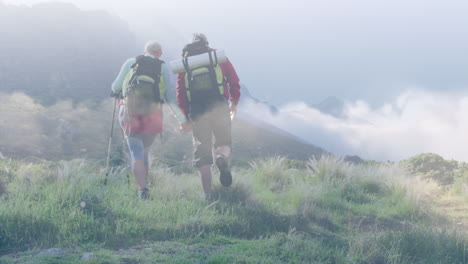 Composite-video-of-clouds-against-caucasian-couple-hiking-on-the-mountains
