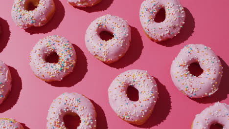 Video-Von-Donuts-Mit-Zuckerguss-Auf-Rosa-Hintergrund