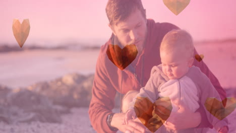 Animation-of-heart-icons-over-caucasian-father-with-child-at-beach