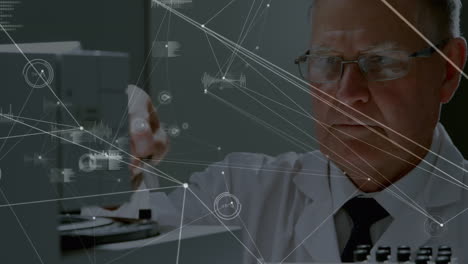 Animation-of-connected-dots,-graph-icons,-caucasian-male-scientist-placing-liquid-in-machine