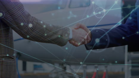 Animation-of-network-of-connections-over-caucasian-businessmen-shaking-hands-on-airport