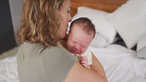 Video-of-happy-caucasian-mother-hugging-newborn-baby
