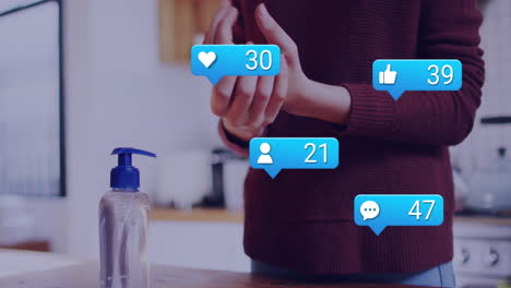 Animation-of-social-media-icons-with-numbers-over-caucasian-woman-disinfecting-hands