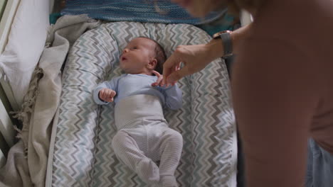 Video-of-caucasian-mother-putting-asleep-newborn-baby