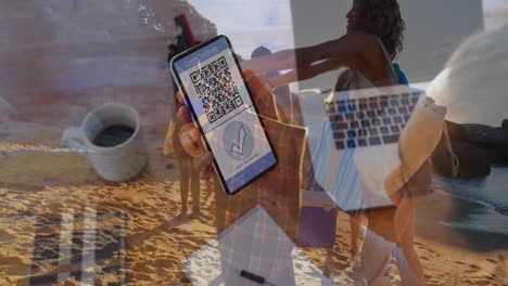 Animation-of-woman-with-covid-passport-on-smartphone-over-diverse-friends-on-beach