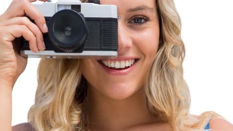 Animation-of-happy-caucasian-woman-holding-camera-over-white-background