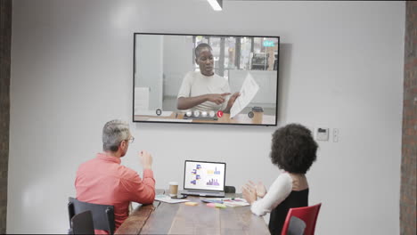 Diverse-business-people-on-video-call-with-african-american-female-colleague-on-screen