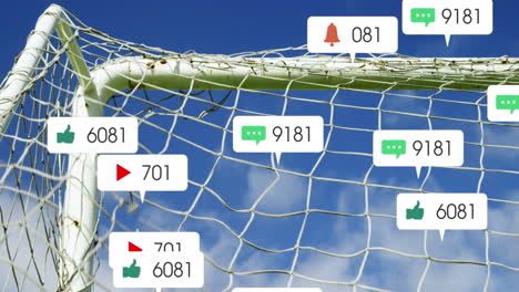 Animation-of-social-media-icons-floating-against-close-up-of-a-goal-post