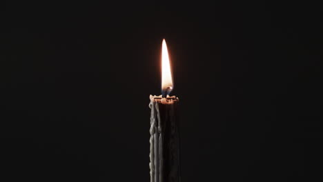 Video-of-green-candles-with-white-flame-and-copy-space-on-black-background