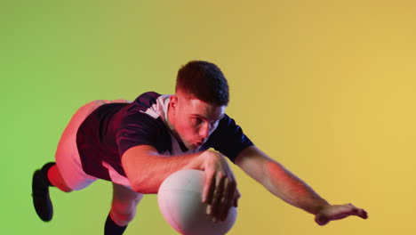 Caucasian-male-rugby-player-jumping-with-rugby-ball-over-yellow-lighting