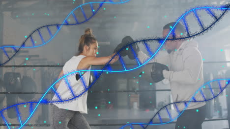 Animation-Von-DNA-Strängen-Und-Datenverarbeitung-über-Verschiedene-Männer-Und-Frauen,-Die-In-Einer-Boxhalle-Trainieren