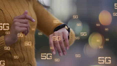 Animation-of-multiple-5g-text-banners-against-mid-section-of-a-woman-using-smartwatch-outdoors