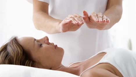Close-up-of-therapist-putting-her-hands-above-the-patient