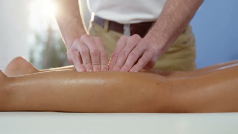 Female-patient-receiving-leg-massage-from-male-physiotherapist