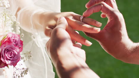 Close-up-of-married-african-american-couple-putting-ring