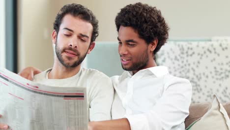 Homosexual-couple-speaking-and-reading-newspaper