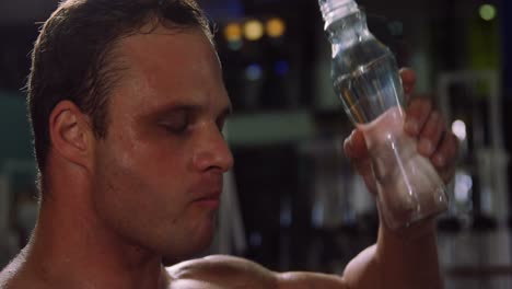 Muscular-man-drinking-water-from-a-bottle
