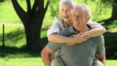 Elderly-man-carrying-his-aged-wife
