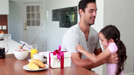 Cute-girl-giving-present-to-father
