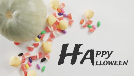 Animation-Von-Halloween-Text-über-Kürbiseimer-Mit-Süßigkeiten-Auf-Grauem-Hintergrund