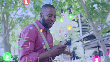 Animation-Von-Social-Media-Reaktionen-über-Einen-Glücklichen-Afroamerikanischen-Mann,-Der-Sein-Smartphone-Nutzt-Und-Isst