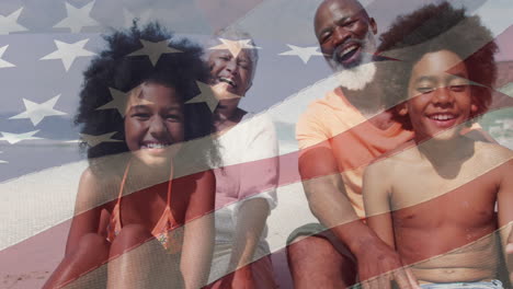 Animation-of-flag-of-usa-over-senior-african-american-couple-with-grandchildren-on-beach