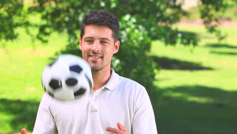 Young-man-playing-with-a-ball-outdoors