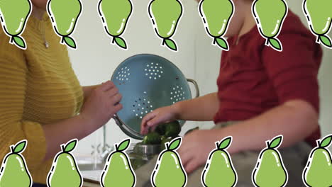 Animation-of-pears-icons-over-caucasian-woman-with-son-cooking