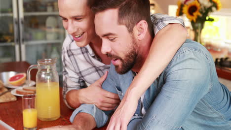 Homosexual-couple-speaking-during-the-breakfast-