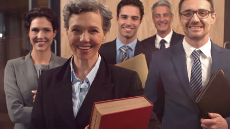 Smiling-lawyers-holding-documents